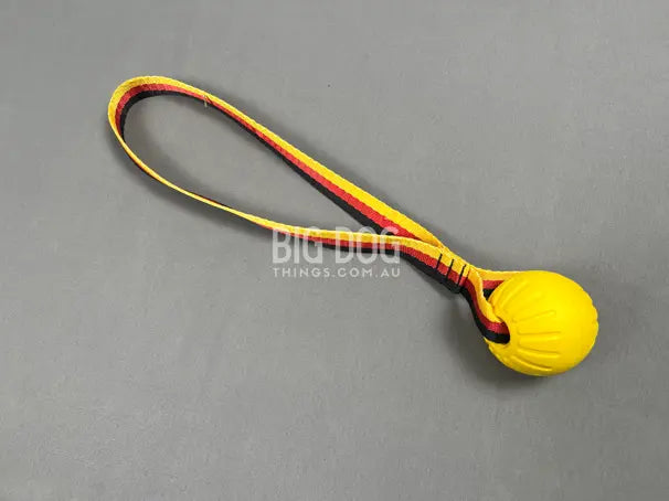 Tug ball on strap