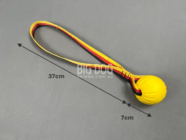 Tug ball on strap