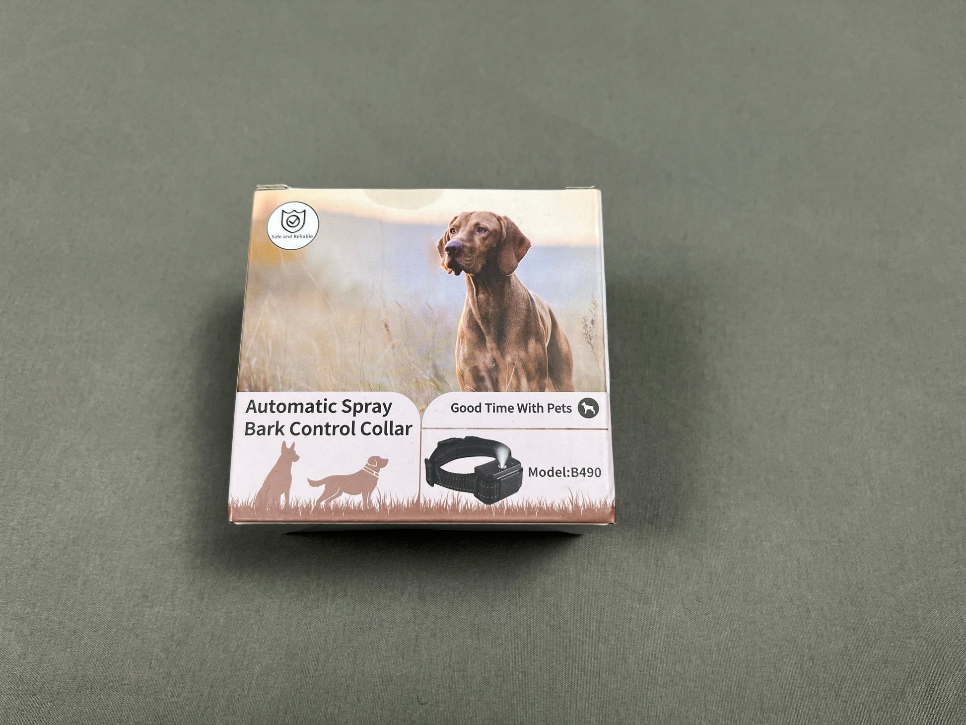 Box of an automatic spray bark control collar for dogs on a gray background