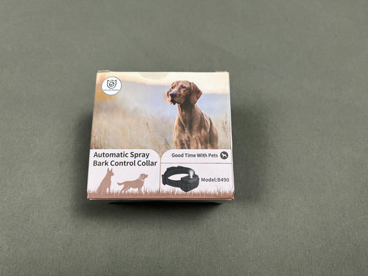 Box of an automatic spray bark control collar for dogs on a gray background